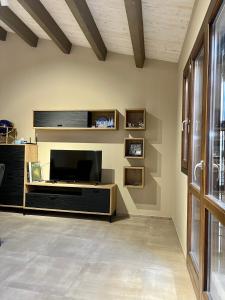 a living room with a large flat screen tv at Blue Sky in Terrasini