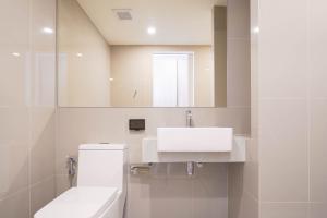 a white bathroom with a sink and a toilet at The Hampton Suites Bangna in Bangna +29 photos