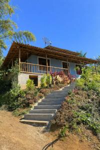 a house with stairs leading up to it at Pouso Ravenala - Refúgio do viajante in Paraty