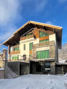 a house in the snow in front at Villa san maria in Bakuriani