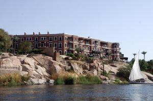 a sail boat in the water in front of a building at SmSm Kato in Aswan