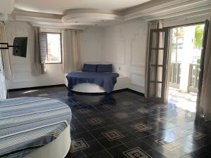 a room with a blue table and a window at A passos do paraíso!! in Lauro de Freitas