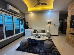 a living room with a couch and a table at Kamala cozy home in Kamala Beach