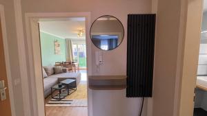a hallway with a mirror and a living room at Charmante Unterkunft im Herzen von Radebeul mit kostenfreien Parkplatz in Radebeul +7 photos