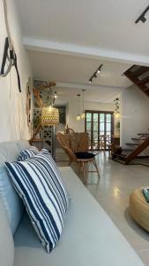 a living room with a bed and a dining room at Casa Aroeira Sahy in Barra do Sahy +35 photos
