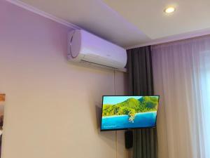 a television on a wall in a hotel room at Balcony Apartman Szeged in Szeged