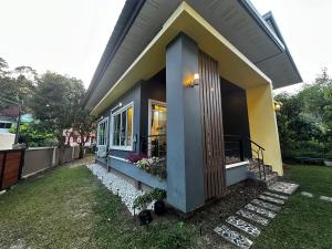a small house with a front door and a yard at Kamala cozy home in Kamala Beach