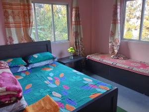 a bedroom with two beds and two windows at MountainBrew Homestay in Takdāh +22 photos