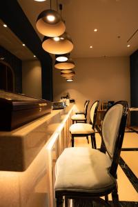 a row of chairs sitting at a bar at Hotel Morina Palace in Dhërmi +222 photos