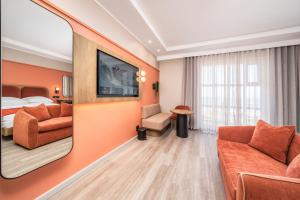 a hotel room with a bed and a tv at Courtyard Hotel Gqeberha in Port Elizabeth