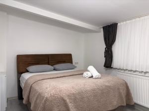 a bedroom with a bed with two stuffed animals on it at Saklıkonak Otel in Isparta
