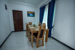 a dining room with a wooden table and chairs at Green Infinity Resorts in Diyatalawa