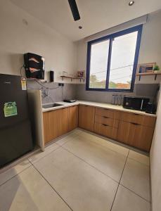 a kitchen with a sink and a window at Spacious 2BHK Group Stay in Vijay Nagar, Indore in Indore