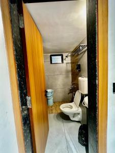 a small bathroom with a toilet and a sink at Spacious 2BHK Group Stay in Vijay Nagar, Indore in Indore
