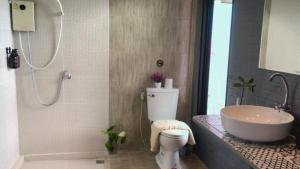a bathroom with a toilet and a sink and a shower at SpamHouse Ranong in Ban Bang Rin (1) +11 photos