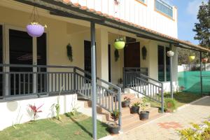 a house with stairs and potted plants on it at serene cottage in Yelagiri