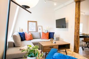 a living room with a couch and a table at Halifax's Most Popular Historic Modern Space in Halifax