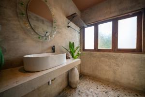 a bathroom with a white sink and a mirror at Cozy Home Saluang in Ban Lua Ka +105 photos