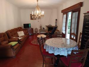 a living room with a table and a couch at Casa da Piedade, Vouzela in Vouzela