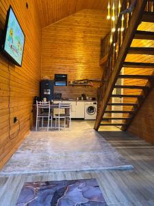 a kitchen and dining room with a table and a staircase at Малинка in Cholpon-Ata