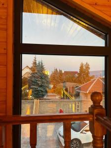 a window with a view of a car in a house at Малинка in Cholpon-Ata
