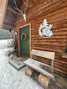 a wooden cabin with a door and a bench in front at Fuchs & Has` in Marienberg +35 photos