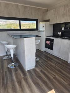 a kitchen with a counter and a counter top at Altos Dique Potrerillos in Potrerillos