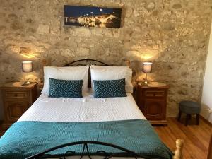 a bedroom with a bed with two night stands and two lamps at La Grange in Yviers
