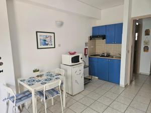 a small kitchen with a table and a microwave at C & A Hotel Apartments in Polis Chrysochous