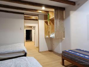 a bedroom with two beds and a hallway at Cálido apartamento in Puno