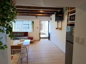 a kitchen and dining room with a table and a refrigerator at Cálido apartamento in Puno +23 photos