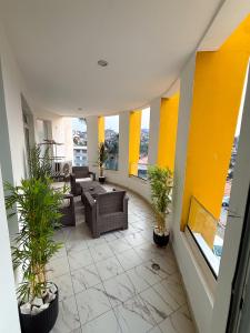 a living room with plants in a building at Bel appartement a Yaoundé Bastos in Yaoundé