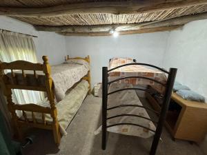 a bedroom with two bunk beds in a room at Maju in Calingasta