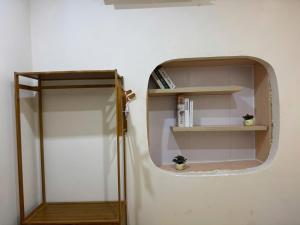 a room with a round shelf and a mirror at Dana Home MT in Danang