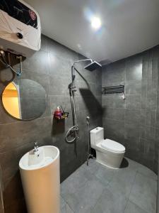 a bathroom with a shower and a toilet and a sink at Dana Home MT in Danang +34 photos