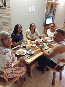 a group of people sitting around a table eating food at Hotel Ejecutivo VIP, La Paz in La Paz