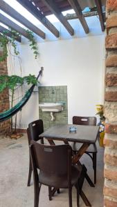 a table and chairs in a room with a sink at Chalés na Hora in Olinda +23 photos