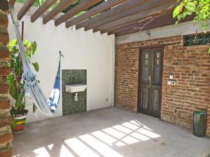 an outdoor bathroom with a sink and a door at Chalés na Hora in Olinda