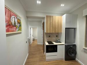 a kitchen with a washer and dryer in a room at Maiden Tower Prestige in Baku