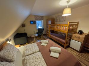 a small room with a bed and a crib at Dom na Klonowym Wzgórzu in Stronie Śląskie +87 photos