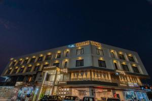 a building with a hotel sign on top of it at Hotel TGR in Ankleshwar