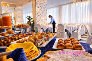 a table filled with different types of pastries and bread at HOTEL AMBRA - Fronte Mare - Vicinissimi al Centro in Milano Marittima