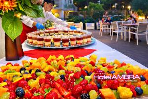 a buffet of fruit and juice on a table at HOTEL AMBRA - Fronte Mare - Vicinissimi al Centro in Milano Marittima