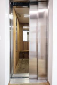a hallway with a glass door leading into a room at Chasa Vital in Sent