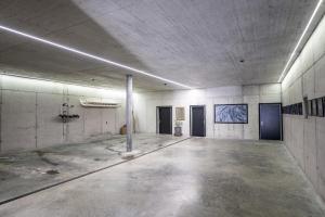 an empty room with a concrete floor in a building at Chasa Vital in Sent +44 photos