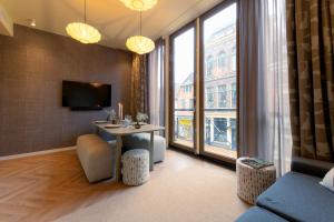 a living room with a table and a large window at Gelk in Groningen