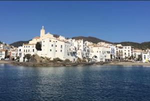 a group of white buildings on the shore of a body of water at AVI PEP in Vilafant