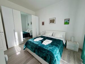 a bedroom with a large bed with a blue blanket at Chianti 22 in Poggibonsi