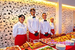 a group of people standing in front of a table of food at HOTEL AMBRA - Fronte Mare - Vicinissimi al Centro in Milano Marittima