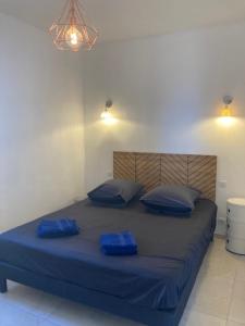 a bed with blue sheets and pillows in a room at Dolce e Lumiu in Lumio +10 photos